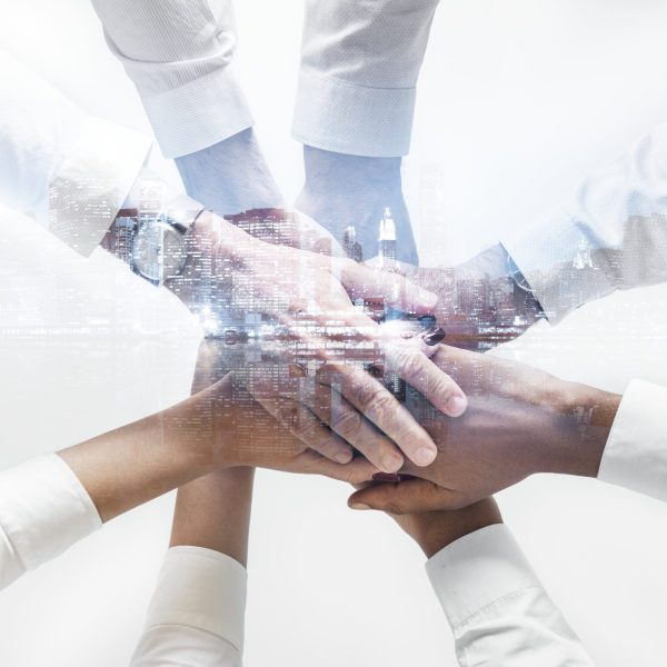 business-team-joining-hands-together-city-background_1 business-team-joining-hands-together-city-background_1
